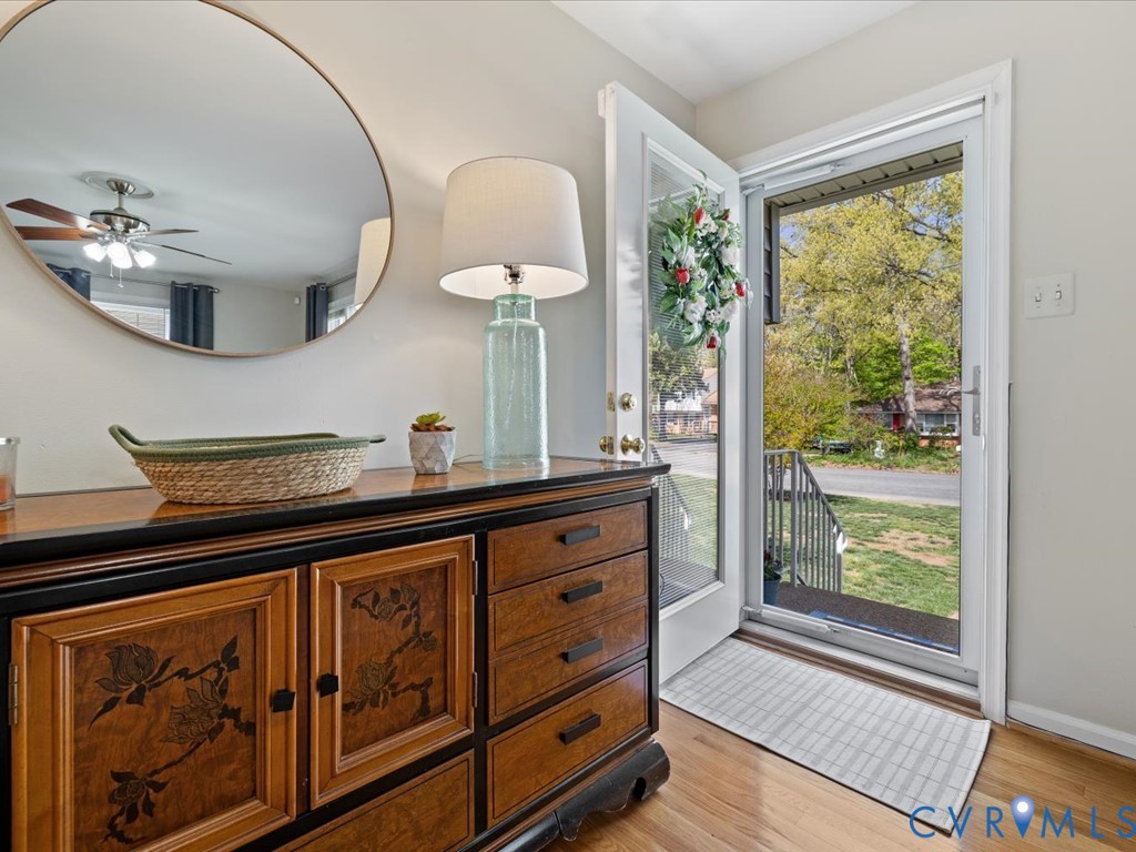 1455 Robindale Road Richmond, VA 23235 - Photo 6 of 29 a kitchen with stainless steel appliances granite countertop a stove a sink and a dining table next to a window