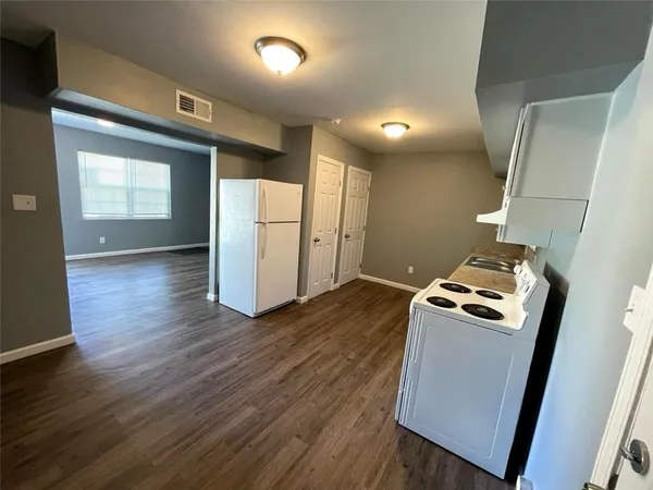 a room with wooden floor and utility