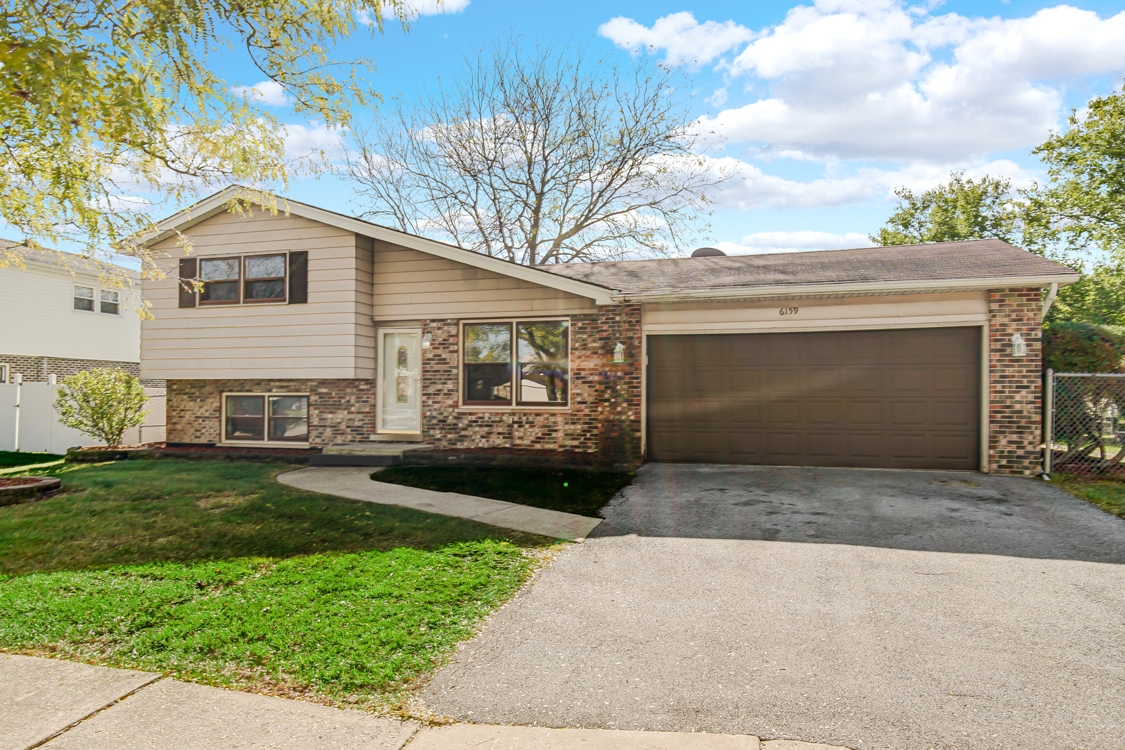 6159 Beechwood Road Matteson, IL 60443 - Photo 1 of 21 a front view of a house with a yard and garage