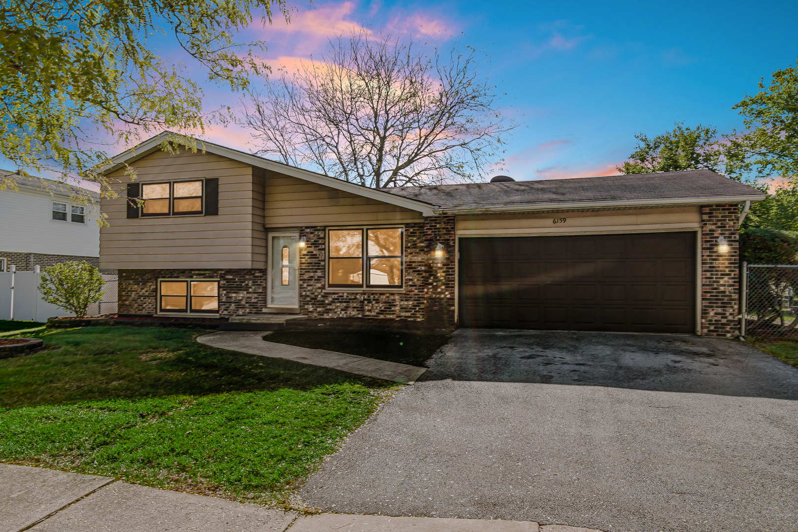 6159 Beechwood Road Matteson, IL 60443 - Photo 21 of 21 a front view of a house with a yard and garage