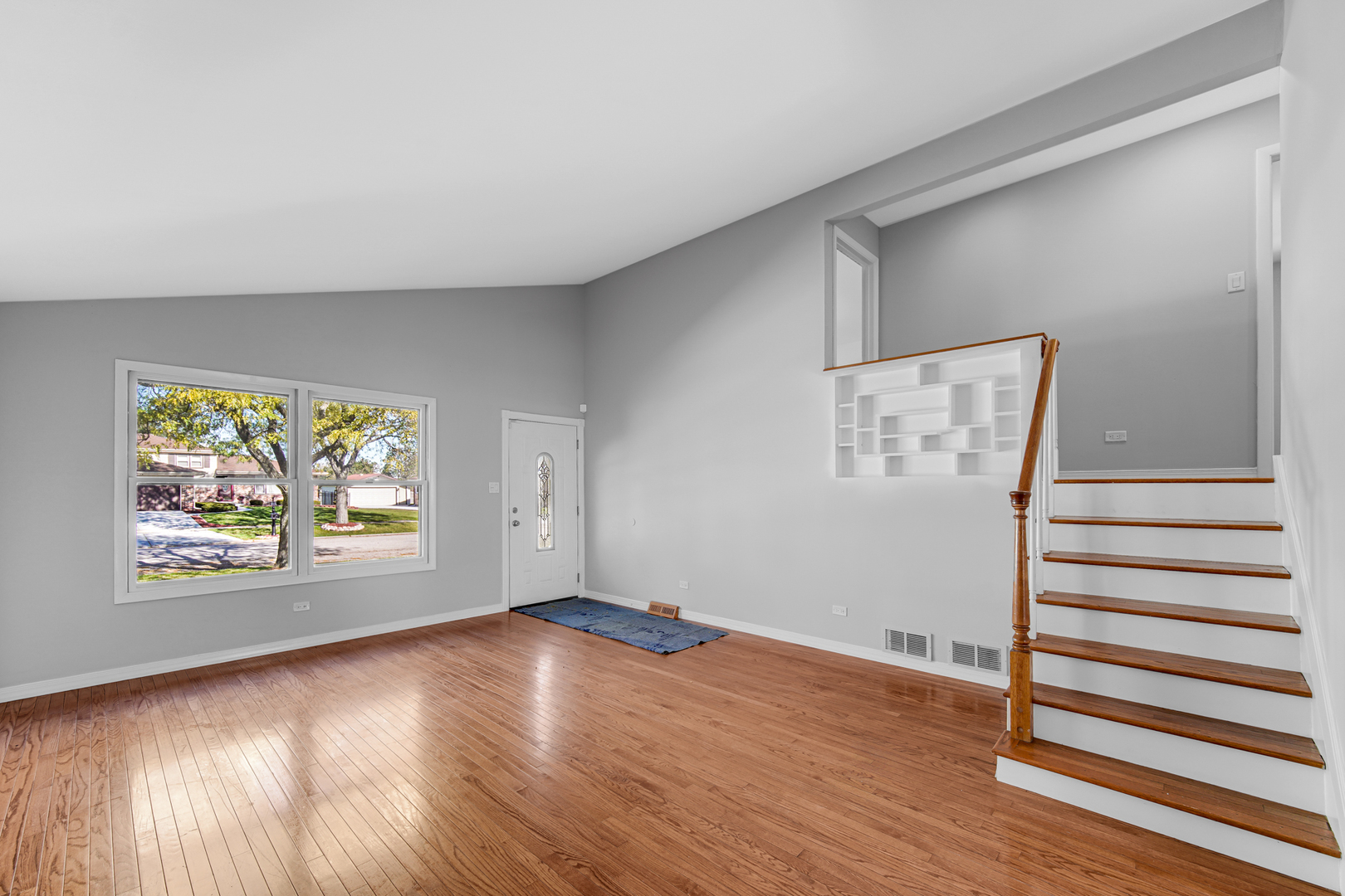 6159 Beechwood Road Matteson, IL 60443 - Photo 5 of 21 an empty room with wooden floor and windows