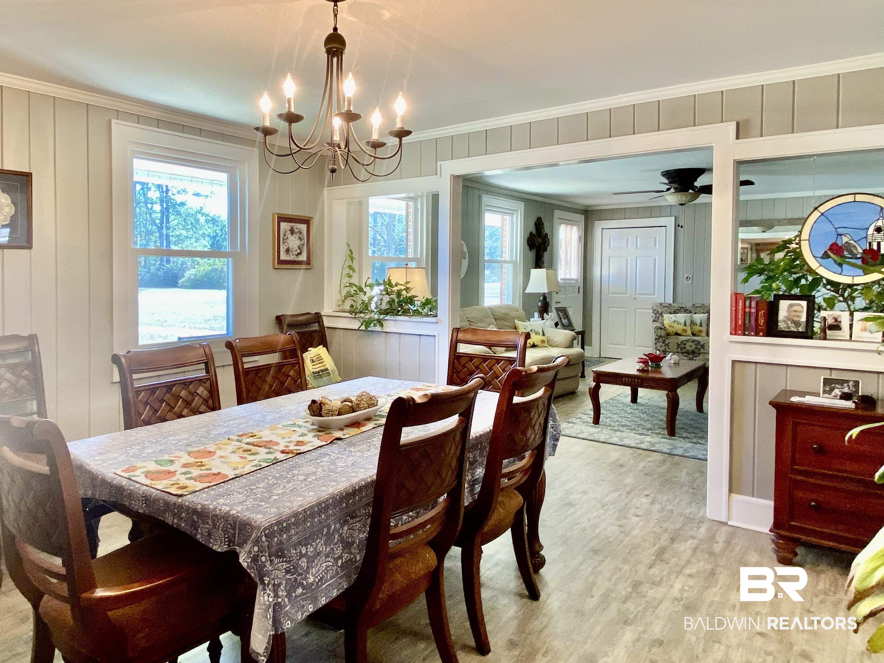 2711 County Road 5 Repton, AL 36475 - Photo 7 of 36 Dining room with ceiling fan with notable chandelier, light hardwood / wood-style flooring, and crown molding