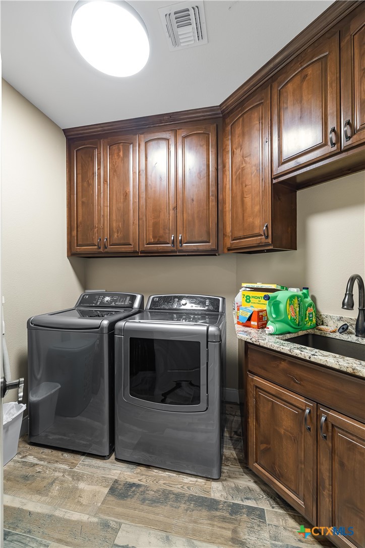 254 Sendera Loop Victoria, TX 77904 - Photo 44 of 48 a kitchen with stainless steel appliances granite countertop a stove a sink and a microwave