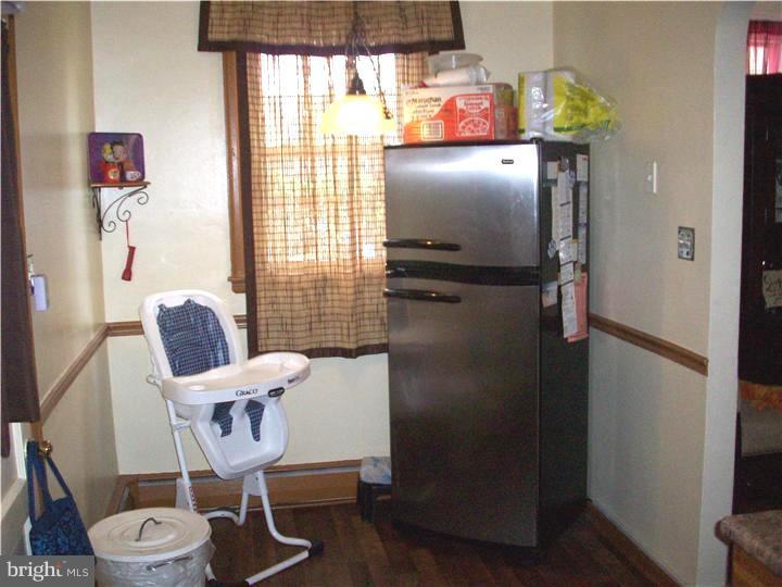 7119 Dungan Road Philadelphia, PA 19111 - Photo 7 of 15 a kitchen with a refrigerator and table chair