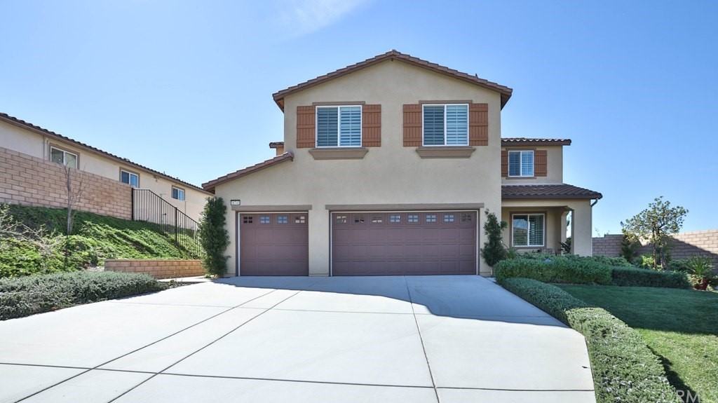 16741 Golden Bluff Loop Riverside, CA 92503 - Photo 1 of 1 a front view of a house with a yard and garage