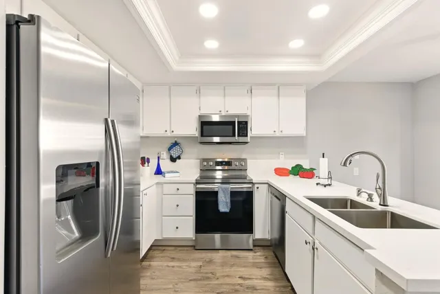 a kitchen with stainless steel appliances granite countertop a refrigerator and a sink