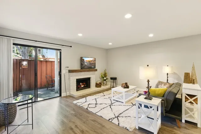 a living room with furniture a fireplace and a flat screen tv
