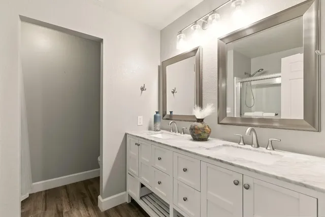 a bathroom with a granite countertop sink and a mirror