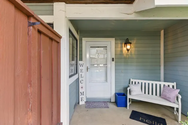 a view of a porch with a door and wooden floor