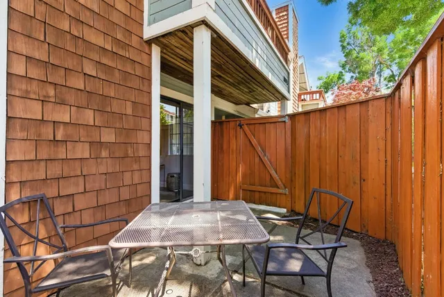 a backyard of a house with table and chairs