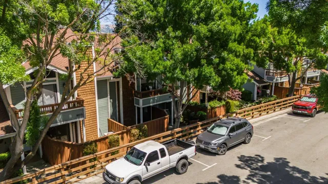 a view of a patio with table and chairs and a large tree