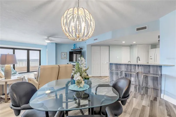 a view of a dining room with furniture wooden floor and chandelier