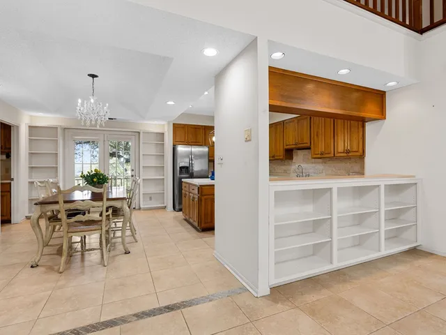 a dining room with furniture and a kitchen view