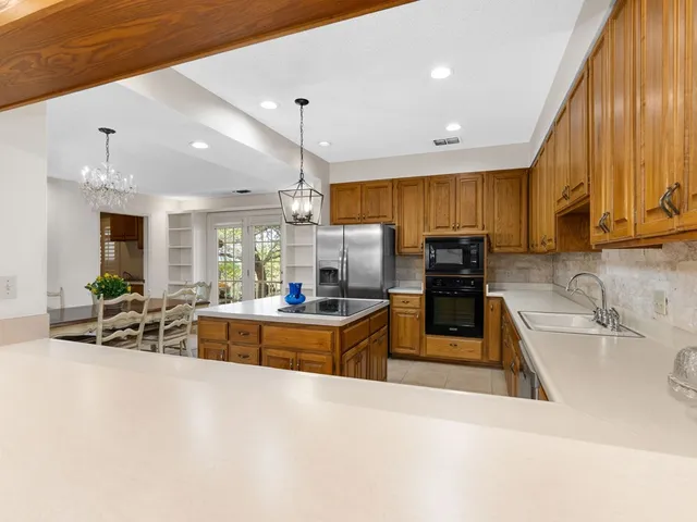 a kitchen with stainless steel appliances a sink a stove and a refrigerator