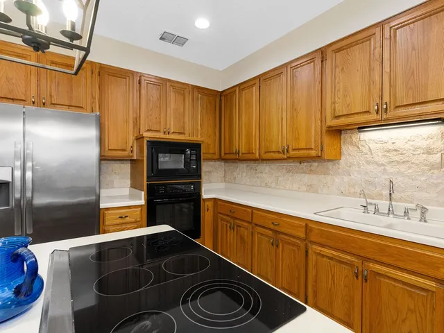 a kitchen with a sink and stainless steel appliances
