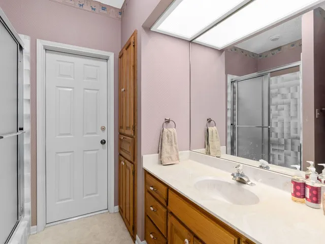 a bathroom with a sink double vanity and a mirror