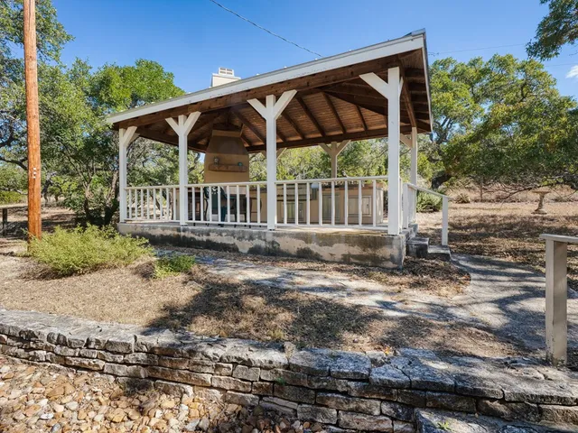 a view of a small yard with wooden deck and furniture