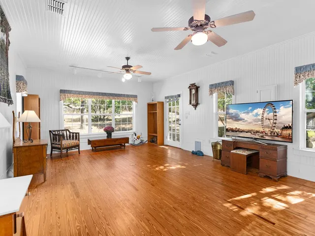 a view of livingroom with kitchen island furniture and a ceiling fan