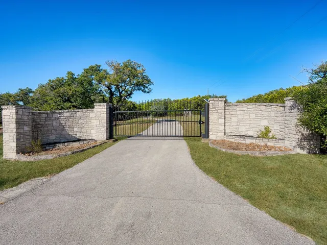 a view of a pathway with a wrought fence