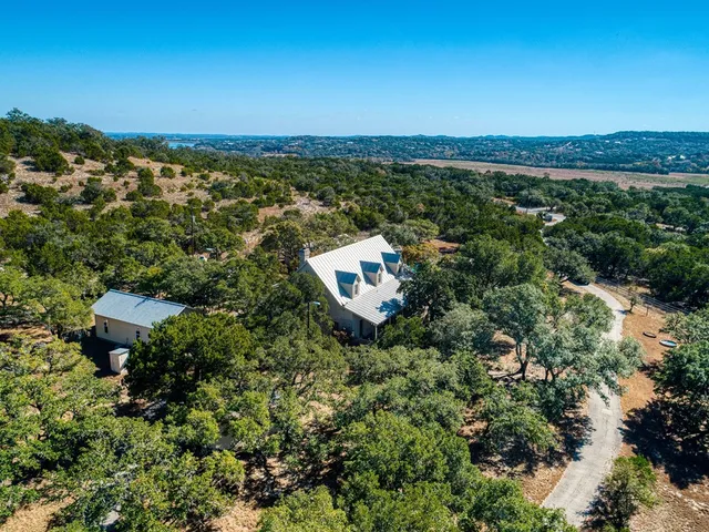 an aerial view of a house with a yard