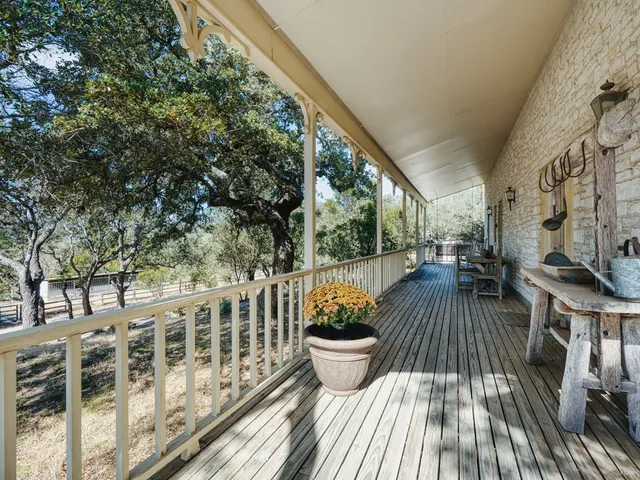 a view of balcony with wooden floor and seating space