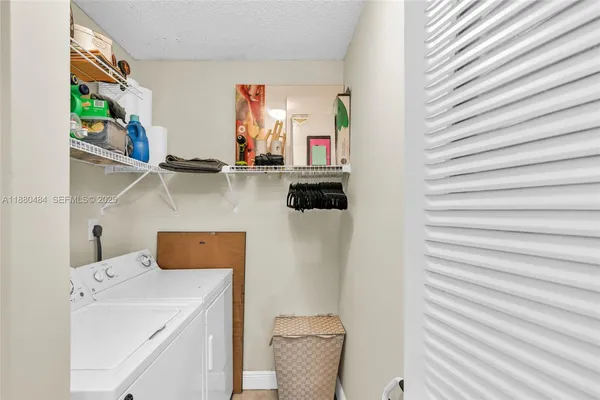 a bathroom with a sink and a washer dryer
