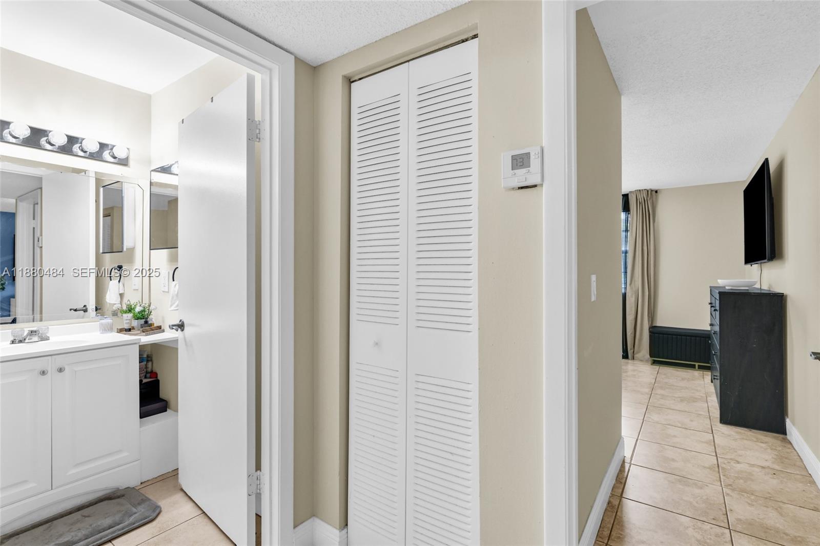 1255 Southwest 46th Avenue, Unit 1713 Pompano Beach, FL 33069 - Photo 17 of 37 a view of a bathroom from the hallway