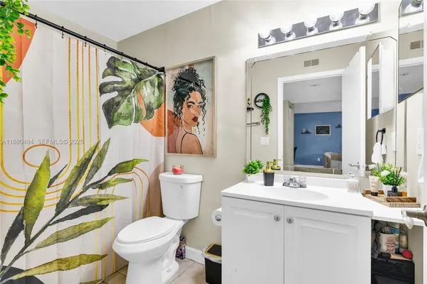 a bathroom with a sink mirror vanity and toilet