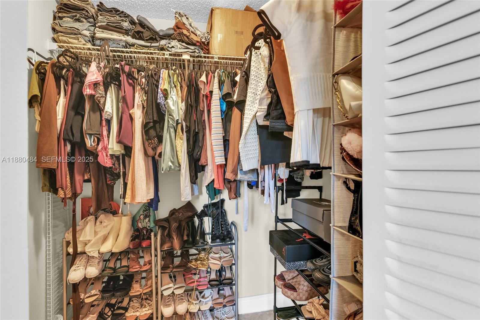 1255 Southwest 46th Avenue, Unit 1713 Pompano Beach, FL 33069 - Photo 20 of 37 a view of walk in closet with clothes and shoes