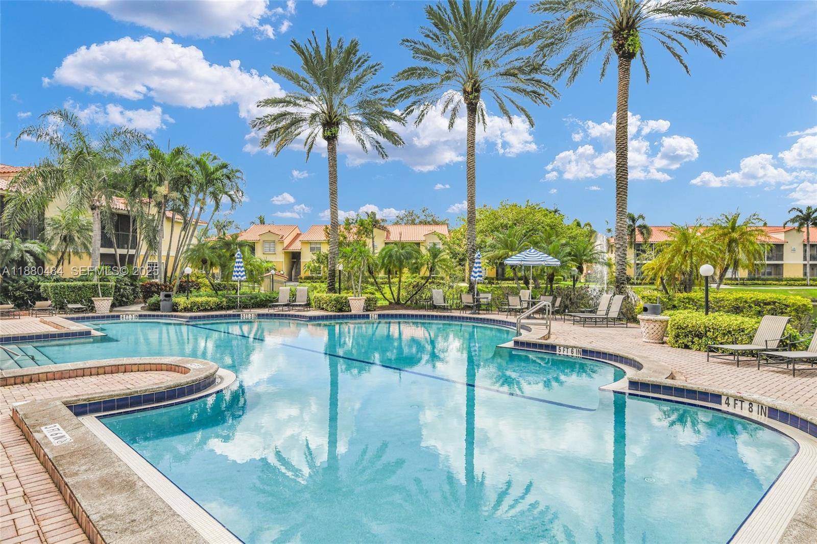 1255 Southwest 46th Avenue, Unit 1713 Pompano Beach, FL 33069 - Photo 28 of 37 a view of a swimming pool with a lounge chairs