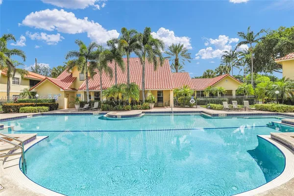 a view of swimming pool with outdoor seating