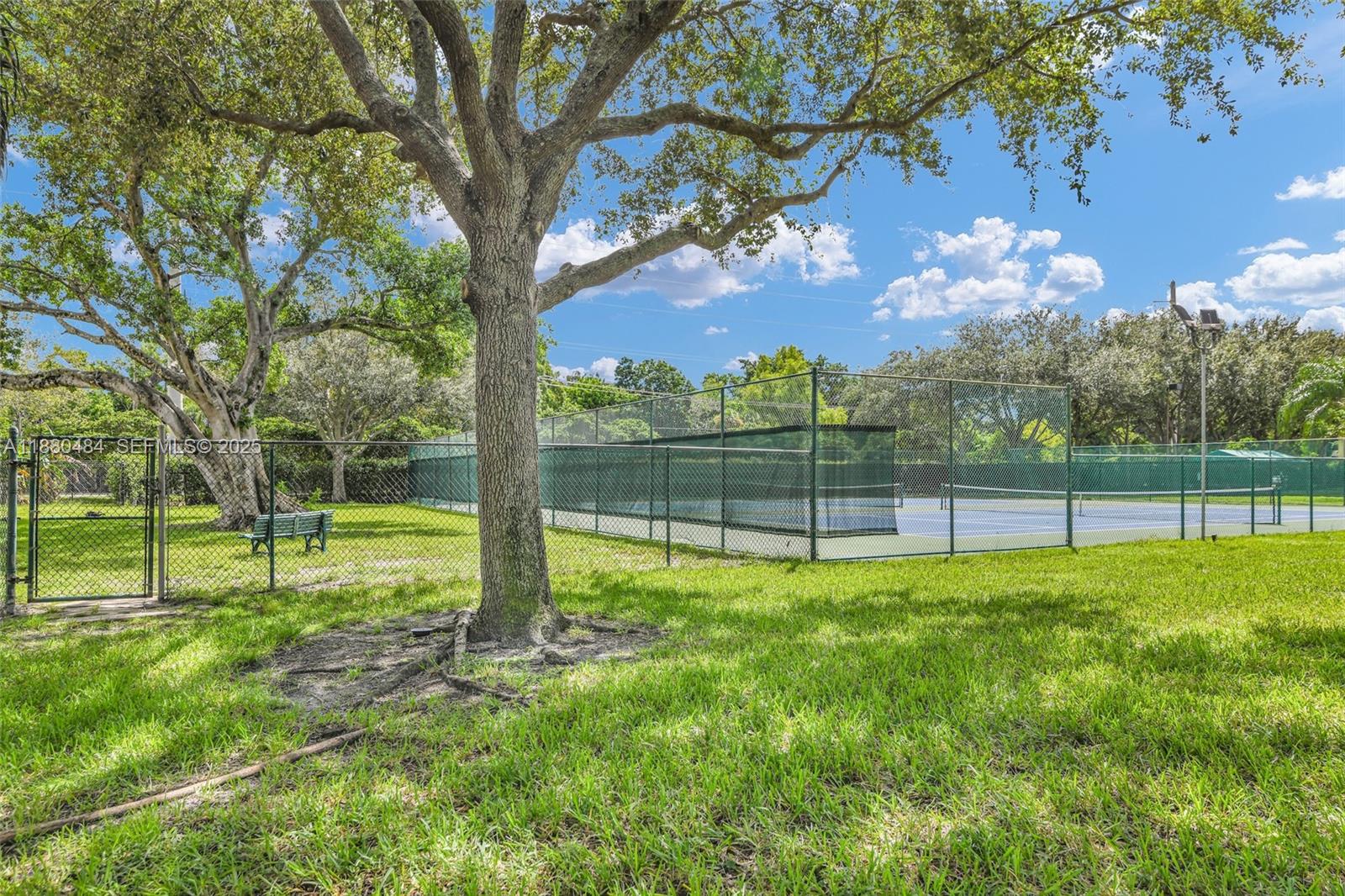 1255 Southwest 46th Avenue, Unit 1713 Pompano Beach, FL 33069 - Photo 36 of 37 a view of a garden with a tree