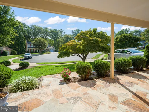 a view of a garden with a building in the background