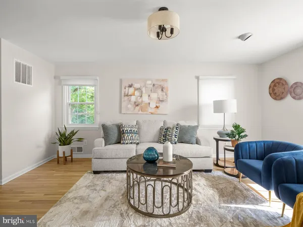 a living room with furniture a rug and a window