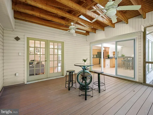 a view of a work space with wooden floor and furniture