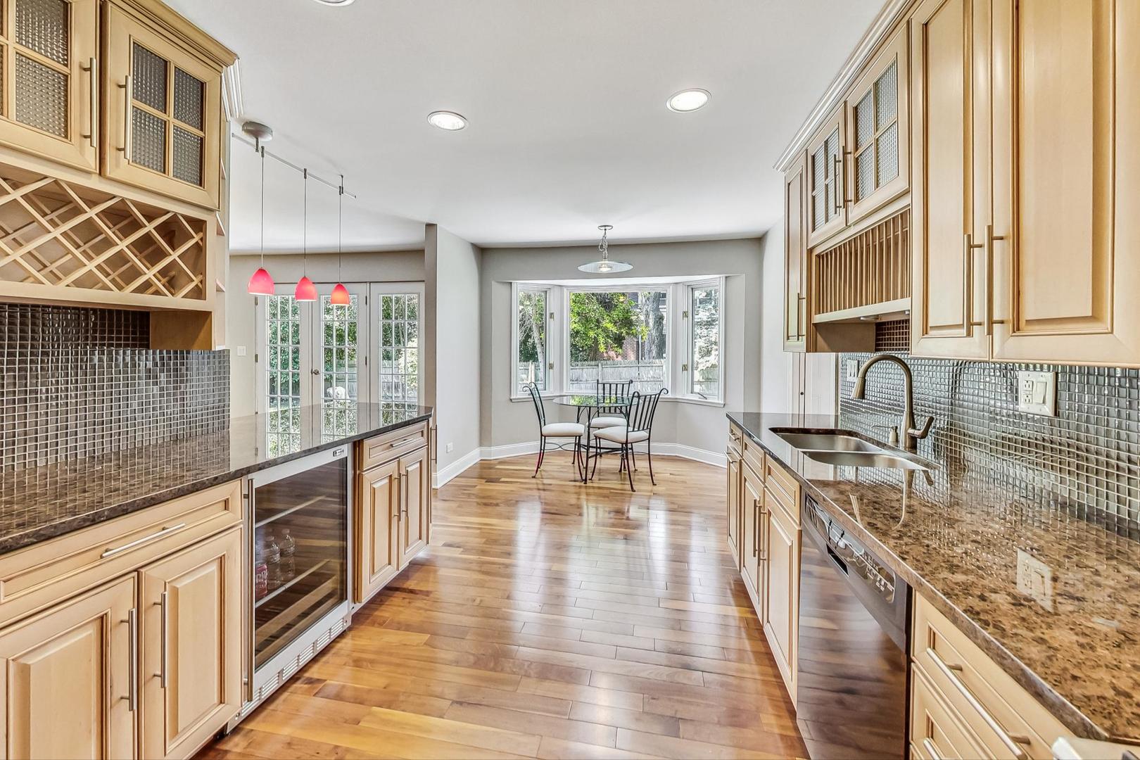 2030 Clover Road Northbrook, IL 60062 - Photo 13 of 44 a large kitchen with stainless steel appliances granite countertop a lot of counter space and wooden floors