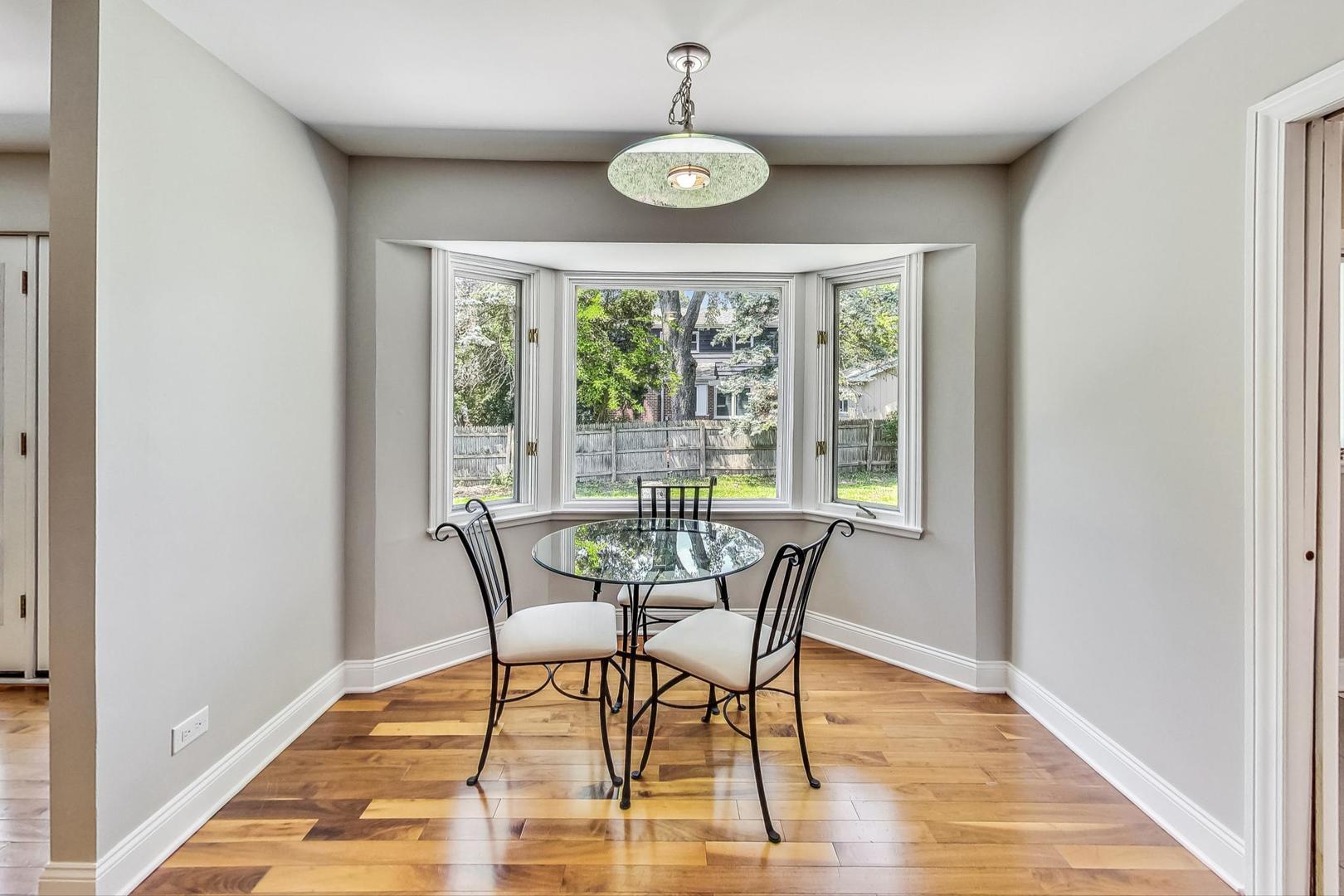 2030 Clover Road Northbrook, IL 60062 - Photo 14 of 44 a dining room with wooden floor a chandelier and windows