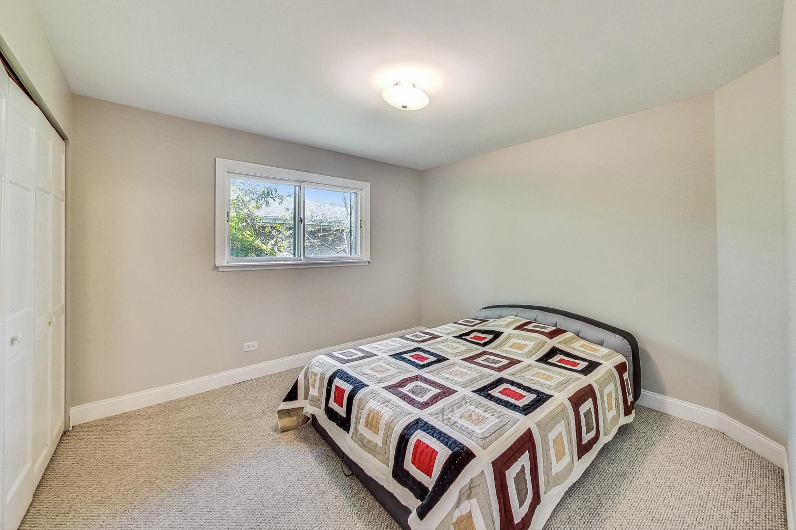 2030 Clover Road Northbrook, IL 60062 - Photo 28 of 44 a bedroom with a bed and a window