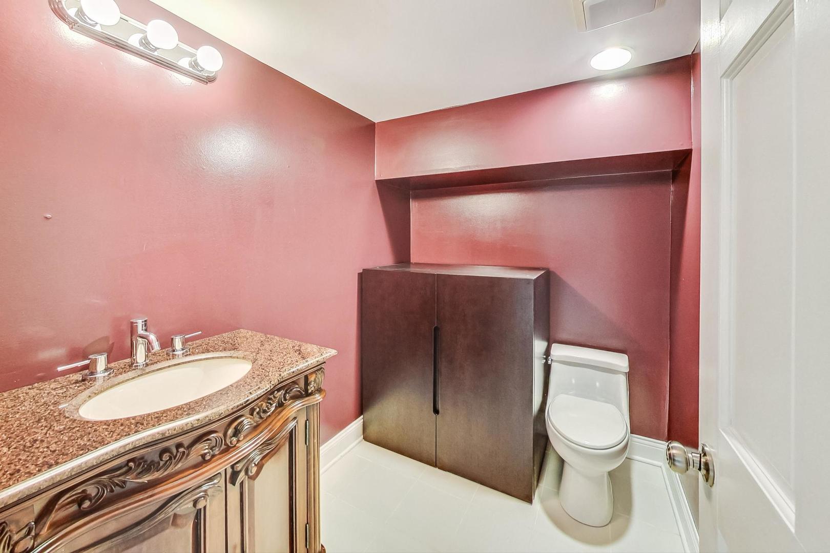 2030 Clover Road Northbrook, IL 60062 - Photo 36 of 44 a bathroom with a granite countertop sink toilet and shower