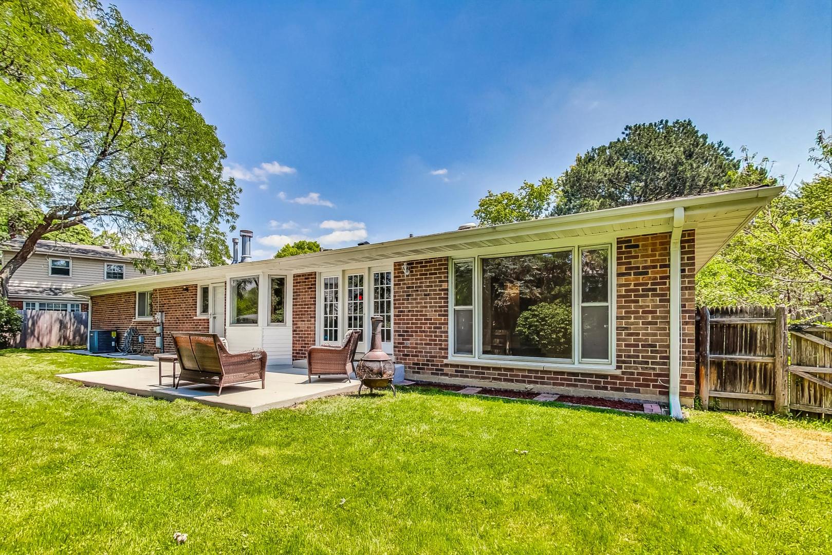 2030 Clover Road Northbrook, IL 60062 - Photo 37 of 44 a front view of a house with a garden and patio