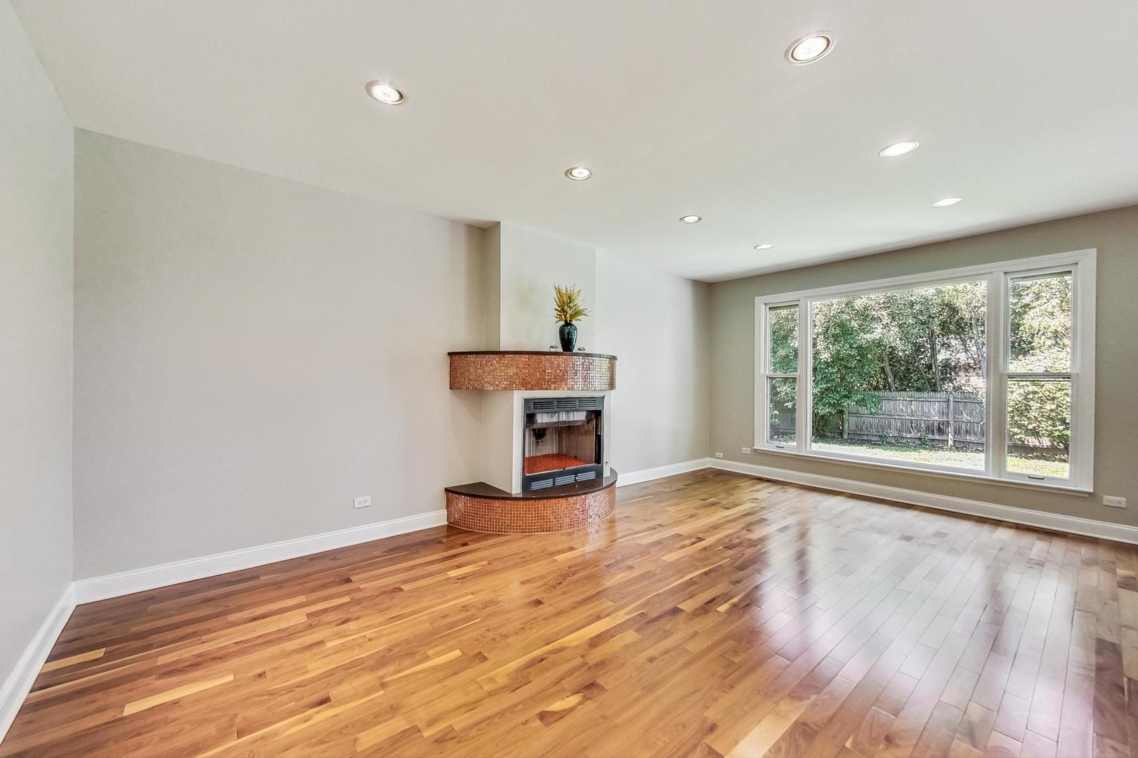 2030 Clover Road Northbrook, IL 60062 - Photo 6 of 44 a view of a room with wooden floor and a fireplace