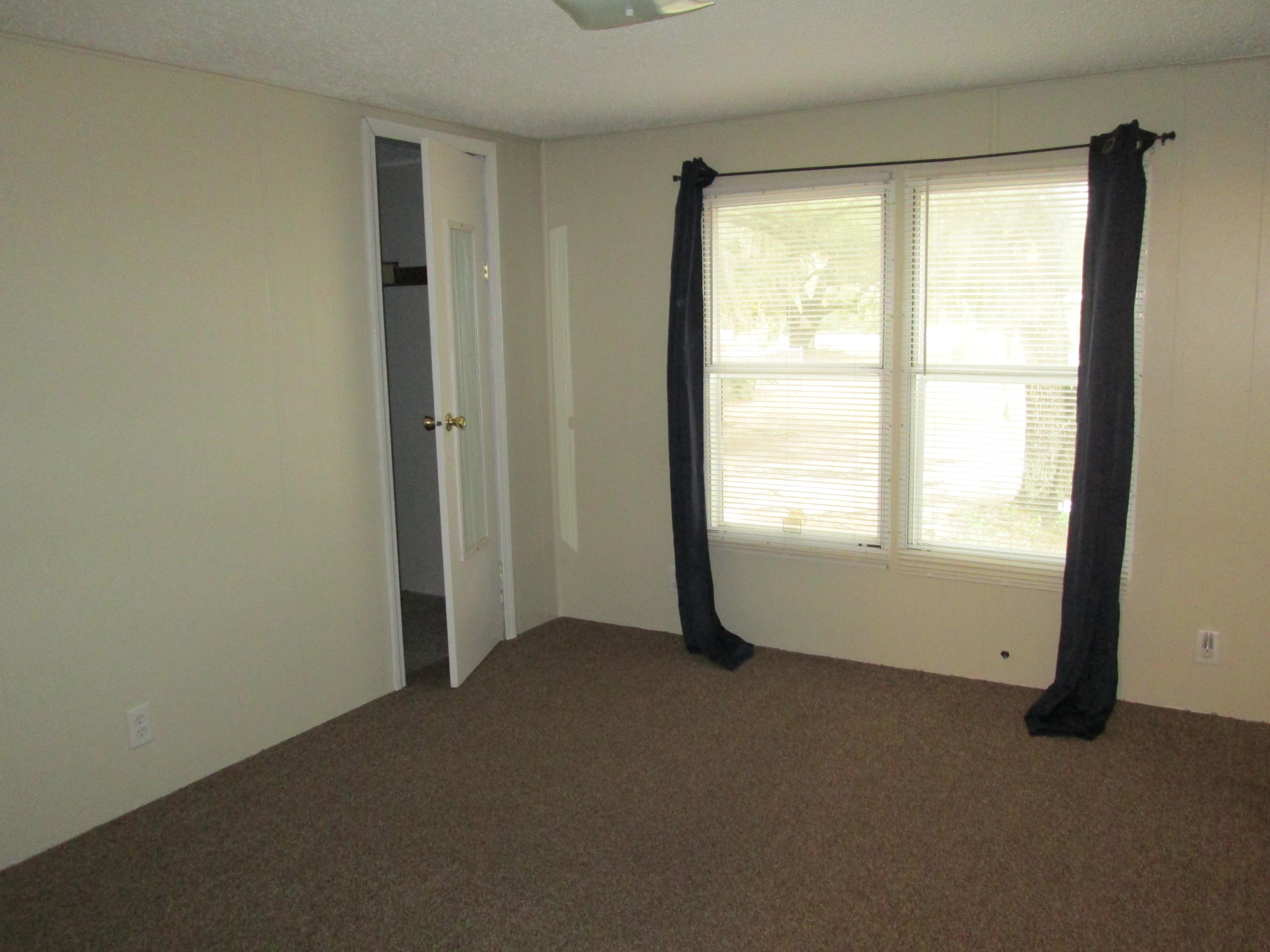 2765 Ola Broxson Road Navarre, FL 32566 - Photo 19 of 20 a view of an empty room with a window