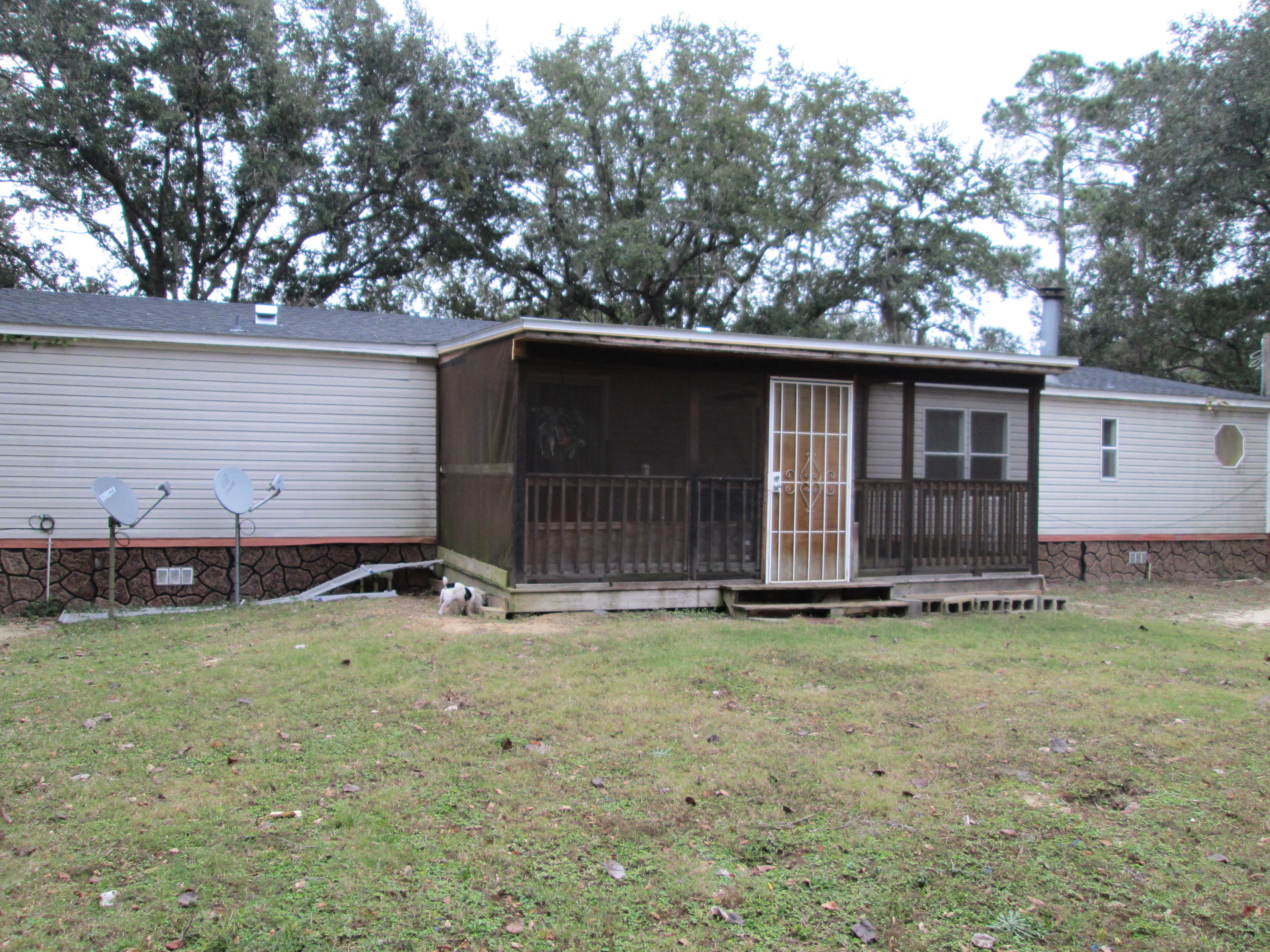 2765 Ola Broxson Road Navarre, FL 32566 - Photo 4 of 20 a house with trees in the background