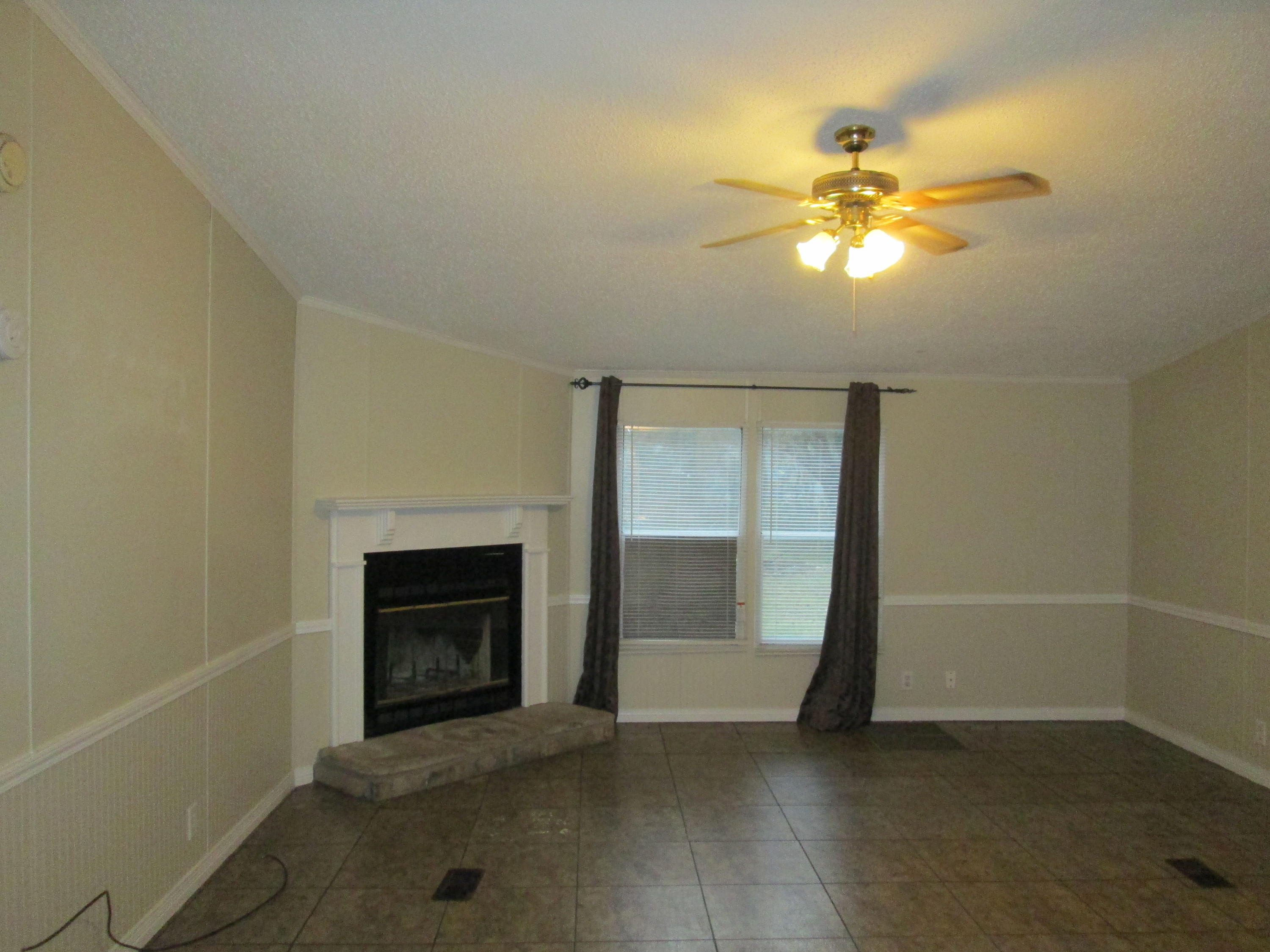 2765 Ola Broxson Road Navarre, FL 32566 - Photo 7 of 20 a view of an empty room with a fireplace