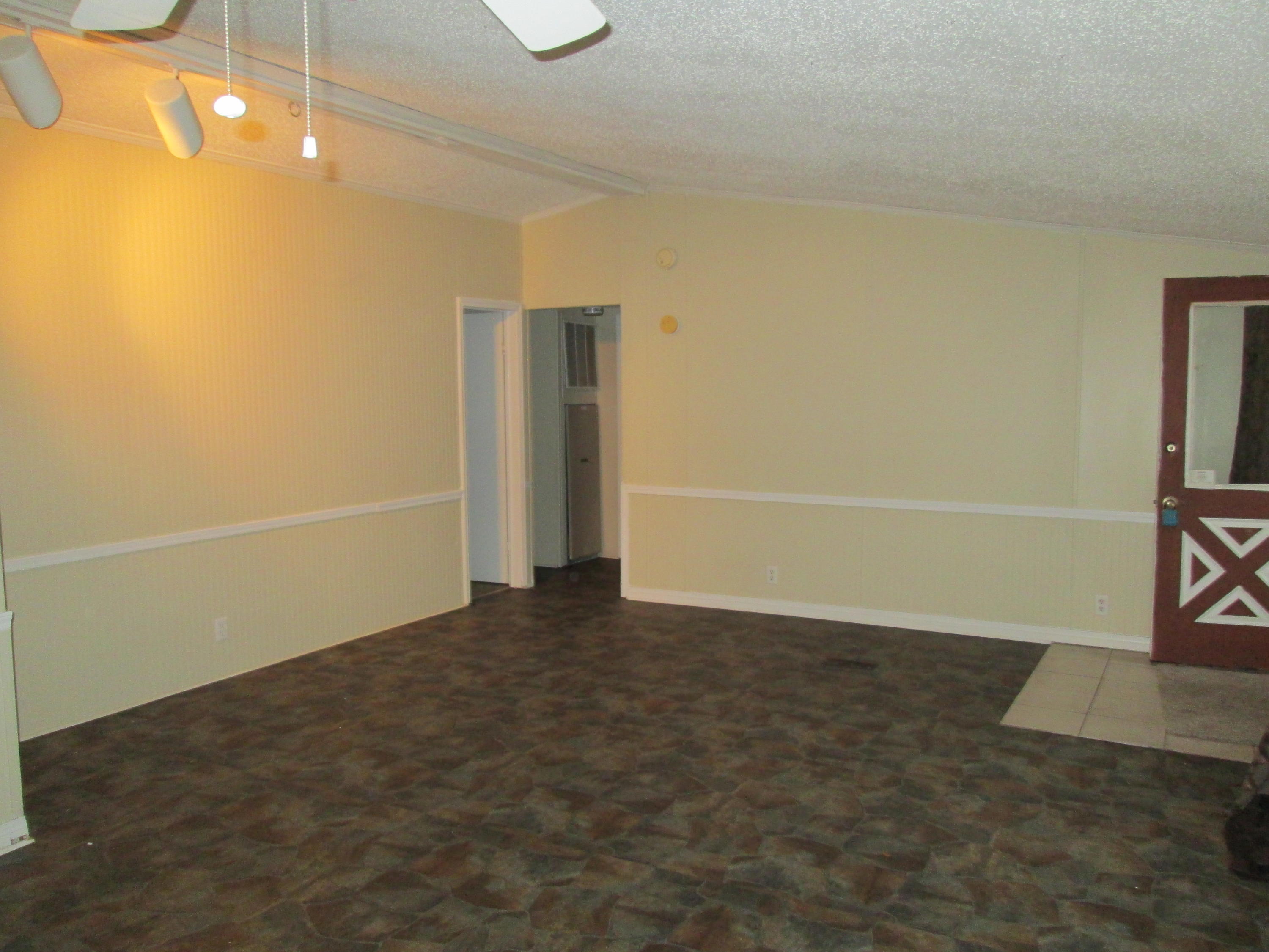 2765 Ola Broxson Road Navarre, FL 32566 - Photo 10 of 20 an empty room with wooden floor
