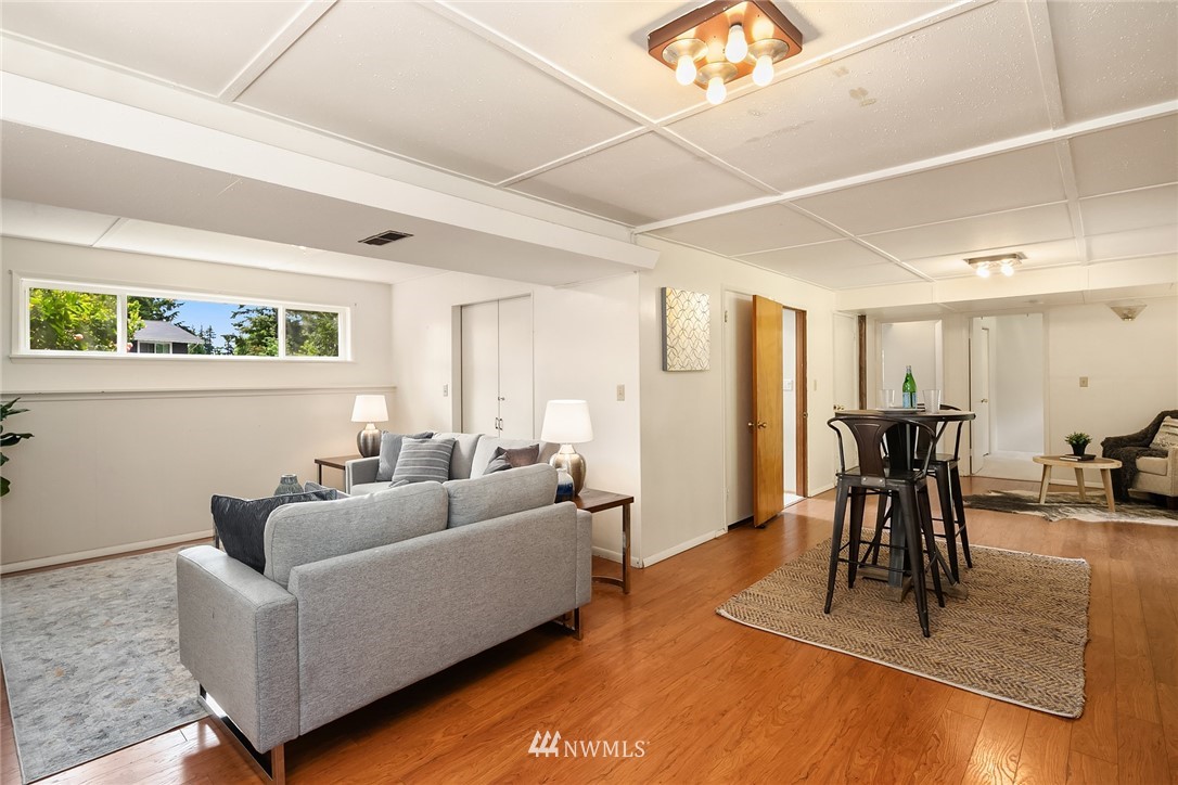 9229 217th Place Southwest Edmonds, WA 98020 - Photo 18 of 38 a living room with furniture a wooden floor and a window
