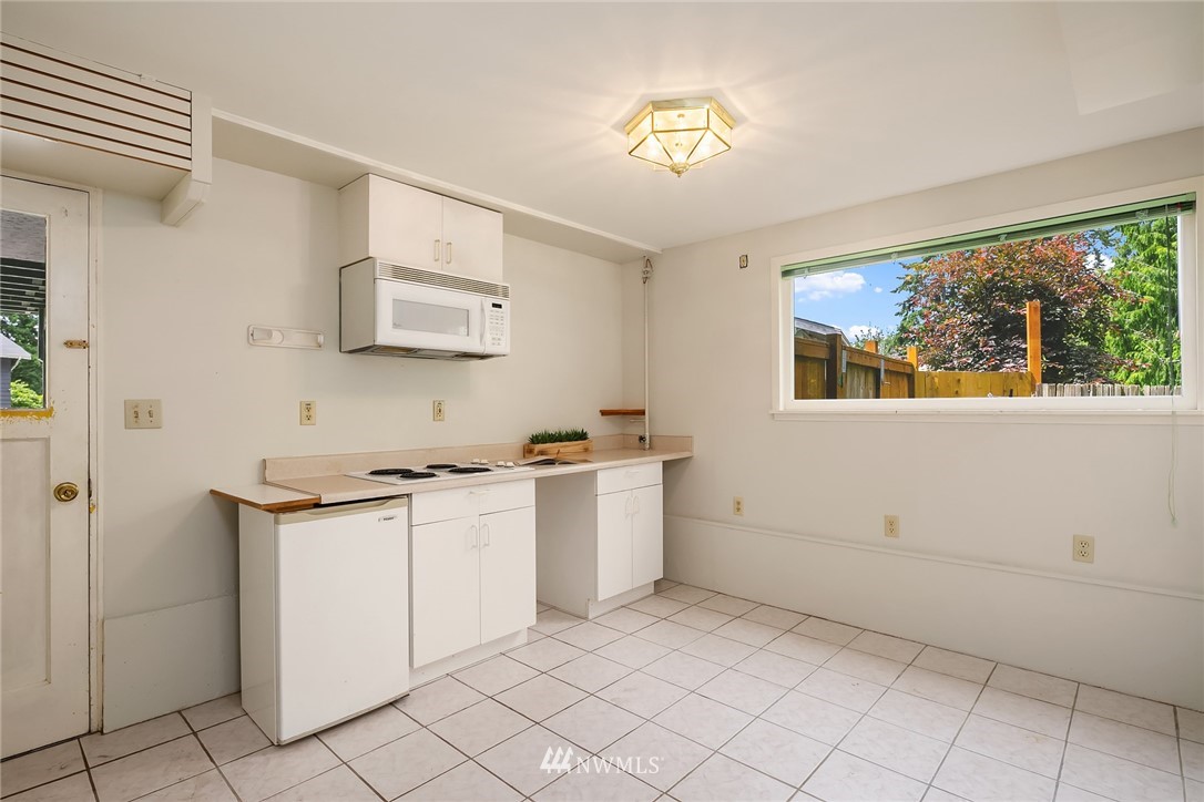 9229 217th Place Southwest Edmonds, WA 98020 - Photo 21 of 38 a kitchen with a stove and a refrigerator