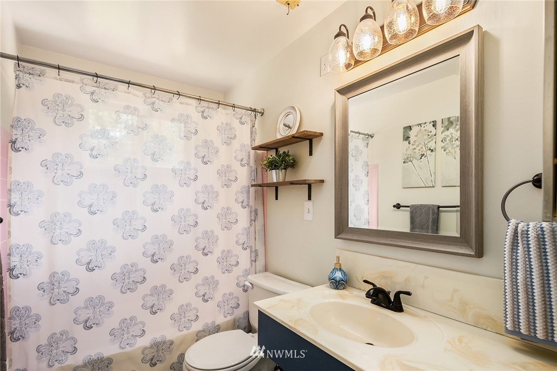 9229 217th Place Southwest Edmonds, WA 98020 - Photo 32 of 38 a bathroom with a sink and a mirror