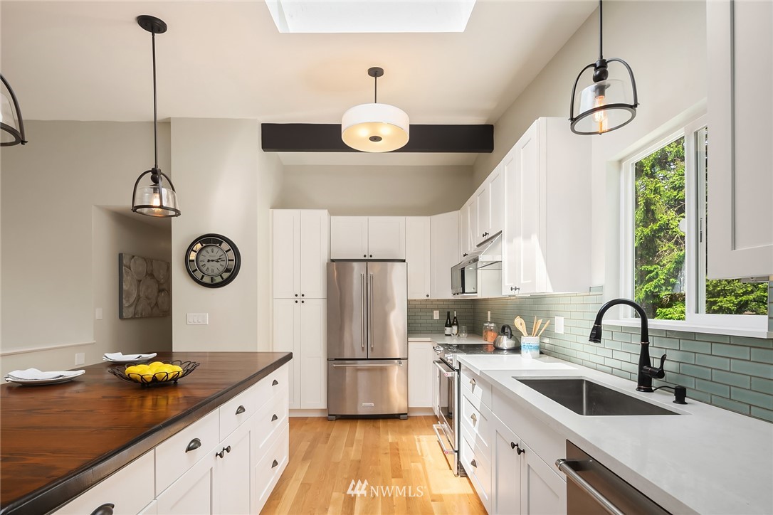 9229 217th Place Southwest Edmonds, WA 98020 - Photo 7 of 38 a kitchen with a refrigerator a sink and cabinets