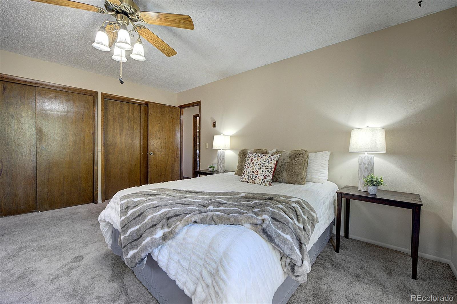 6561 Ridgeview Drive Morrison, CO 80465 - Photo 19 of 36 a bedroom with a bed and a chandelier